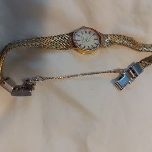 Ladies gold plated Bulova with 17 or 18 diamonds in working parts,  safety chain